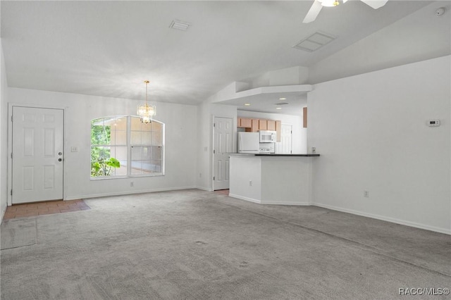 unfurnished living room with visible vents, baseboards, carpet, ceiling fan with notable chandelier, and vaulted ceiling