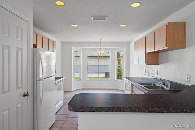 kitchen featuring recessed lighting, white appliances, visible vents, and a sink
