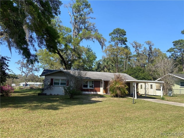 5175 E Tangelo Ln, Inverness, FL 34453 - single story home with concrete driveway, a front lawn, and an attached carport
