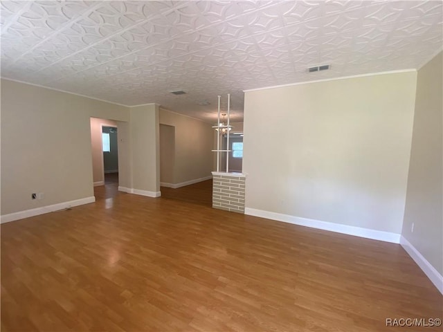 5175 E Tangelo Ln, Inverness, FL 34453 - empty room featuring wood finished floors, crown molding, baseboards, and an ornate ceiling