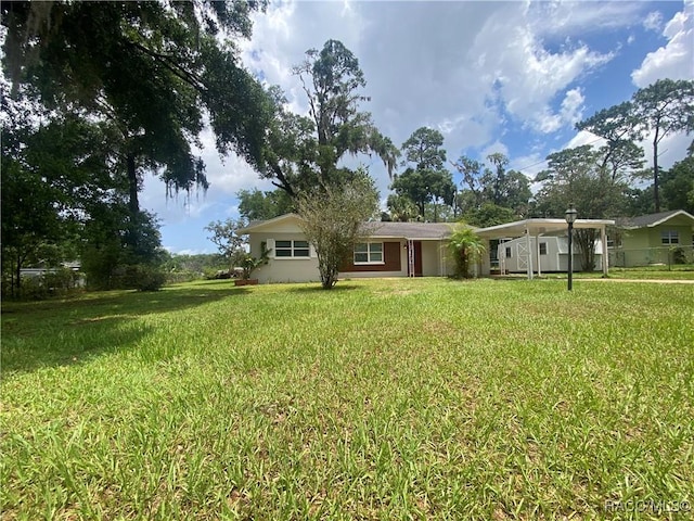 5175 E Tangelo Ln, Inverness, FL 34453 - view of front of home with a front yard and a carport