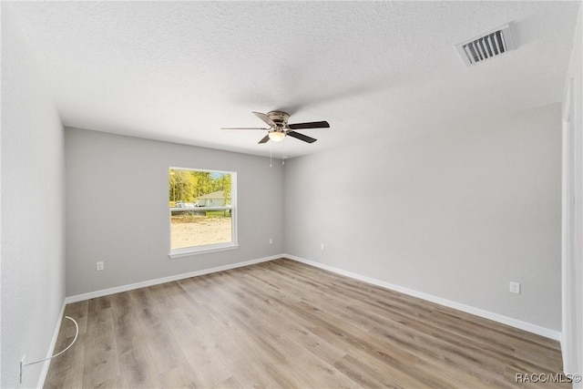 2114 W Magenta Dr, Citrus Springs, FL 34434 - unfurnished room with light wood-type flooring, visible vents, baseboards, a textured ceiling, and ceiling fan