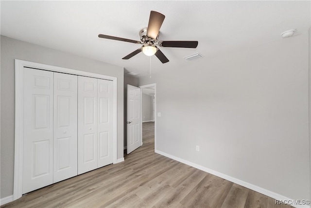 2114 W Magenta Dr, Citrus Springs, FL 34434 - unfurnished bedroom featuring a closet, visible vents, baseboards, and light wood-style flooring