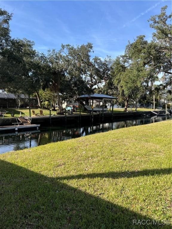 view of property's community featuring a water view and a yard