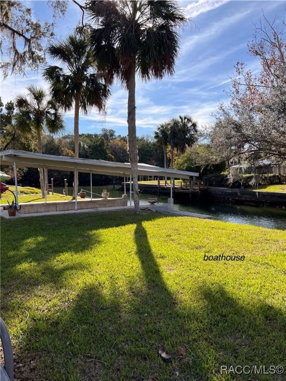 view of property's community featuring a yard and a water view