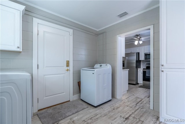 clothes washing area with light hardwood / wood-style flooring, cabinets, ceiling fan, crown molding, and washing machine and dryer