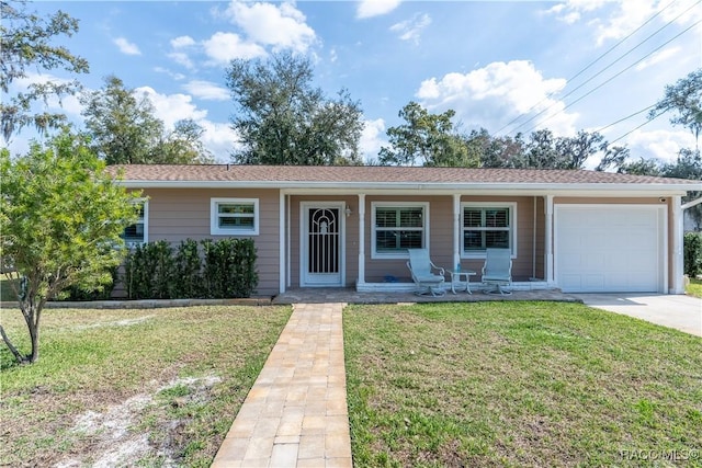 ranch-style home with a garage, a front yard, and covered porch