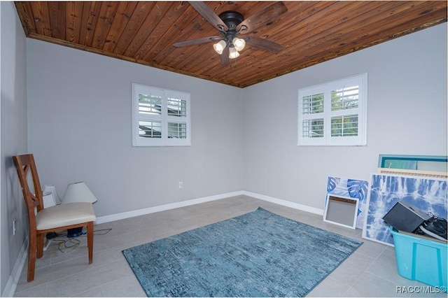 living area with light tile patterned floors, wooden ceiling, and ceiling fan