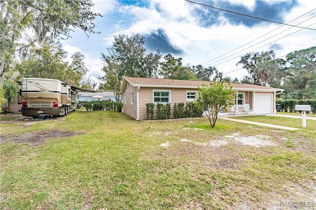 view of front of property with a garage and a front yard