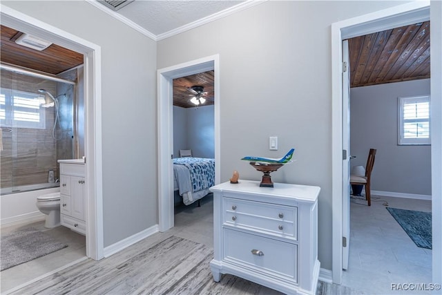 hall featuring wood ceiling, ornamental molding, and a healthy amount of sunlight