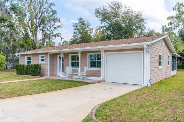 ranch-style home featuring a garage, a front yard, and covered porch