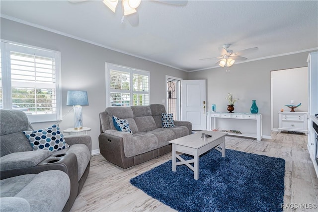 living room with light hardwood / wood-style flooring, ornamental molding, and ceiling fan