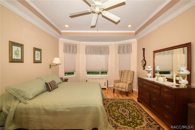 bedroom with ceiling fan, light wood-type flooring, ornamental molding, and radiator