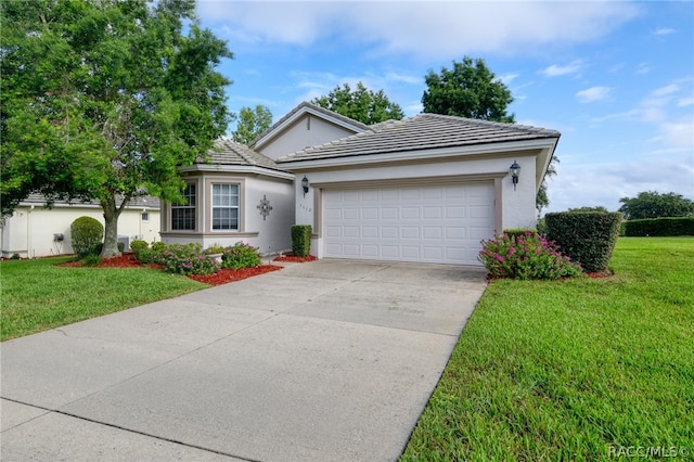 view of front of house with a garage and a front lawn