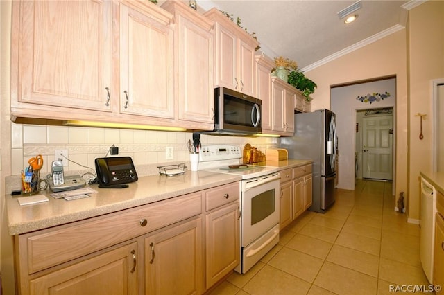 1112 W Diamond Shore Loop Unit 45, Hernando, FL 34442 - kitchen with appliances with stainless steel finishes, crown molding, backsplash, light tile patterned floors, and light countertops