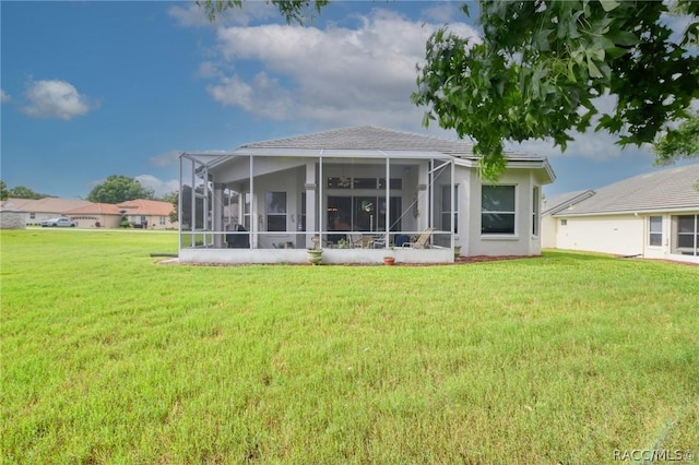 1112 W Diamond Shore Loop Unit 45, Hernando, FL 34442 - rear view of property with a yard, a sunroom, and stucco siding