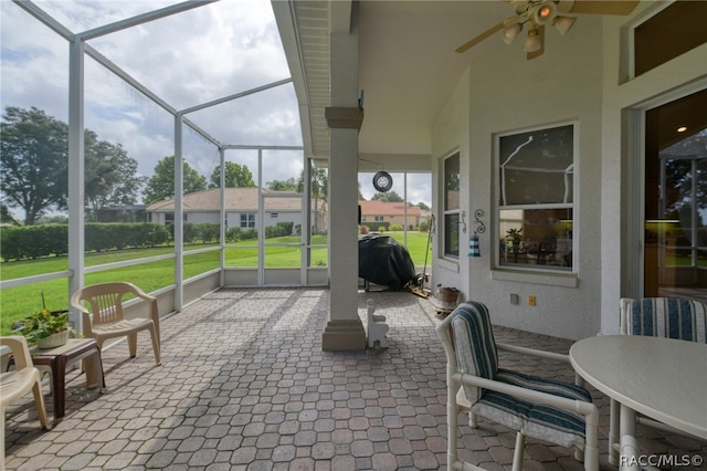 sunroom / solarium featuring a wealth of natural light and ceiling fan