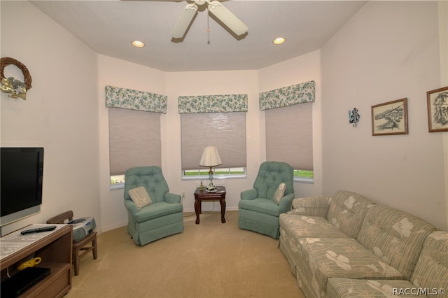 carpeted living room featuring ceiling fan and a healthy amount of sunlight