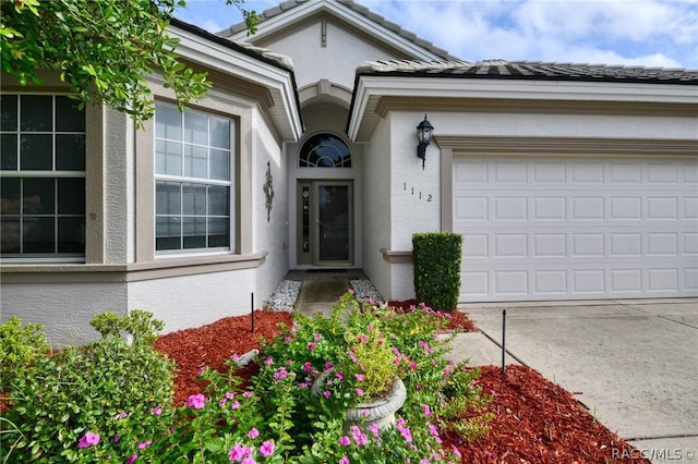 1112 W Diamond Shore Loop Unit 45, Hernando, FL 34442 - entrance to property featuring stucco siding, driveway, and an attached garage