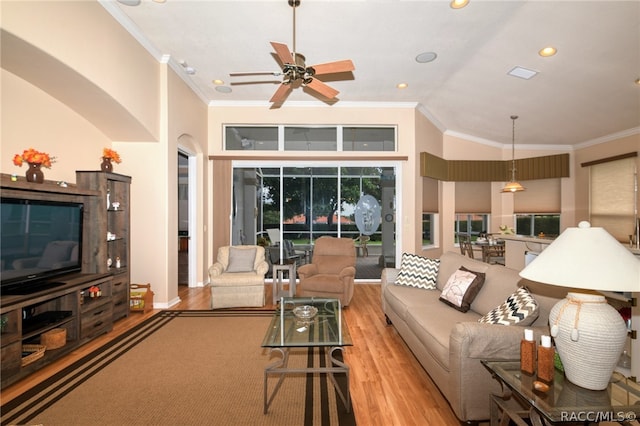 living room with light wood-type flooring, ceiling fan, and ornamental molding