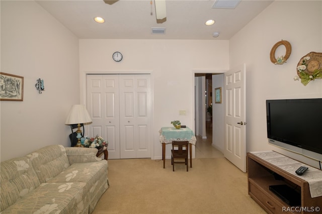 carpeted living room with ceiling fan