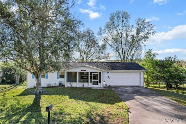 ranch-style home featuring a front yard, concrete driveway, and a garage