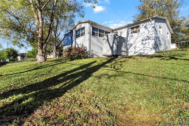 view of property exterior with a lawn