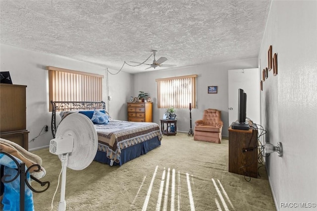 carpeted bedroom with baseboards and a textured ceiling