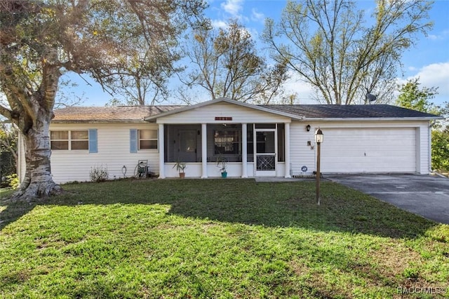 single story home with driveway, an attached garage, a front yard, and a sunroom