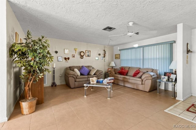 living area featuring light tile patterned floors, visible vents, a textured ceiling, and ceiling fan