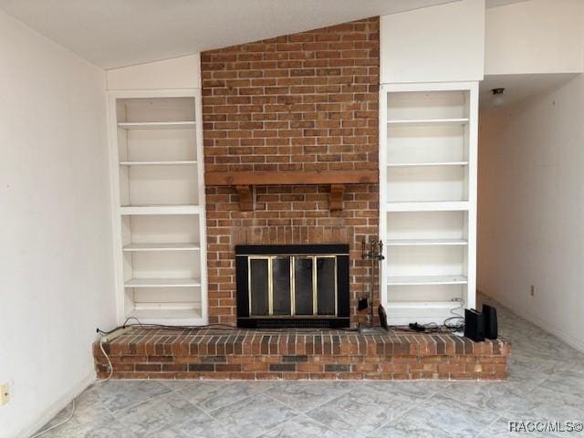 unfurnished living room with a fireplace, built in shelves, and vaulted ceiling