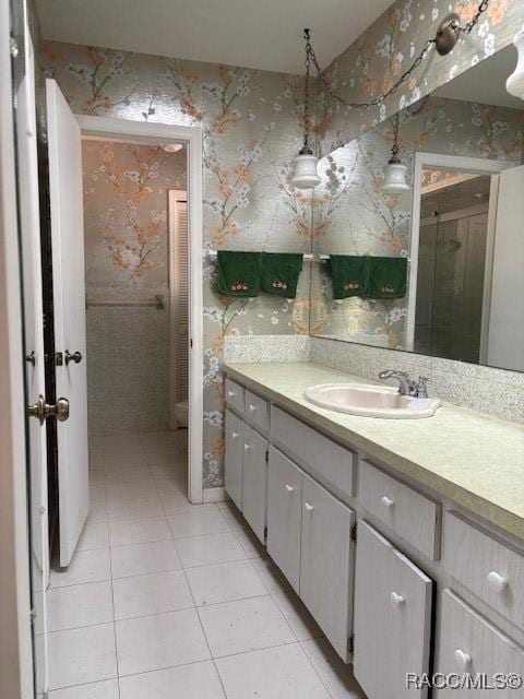 bathroom featuring vanity, an enclosed shower, and tile patterned floors