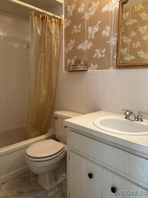 full bathroom with vanity, tile walls, shower / tub combo, and toilet