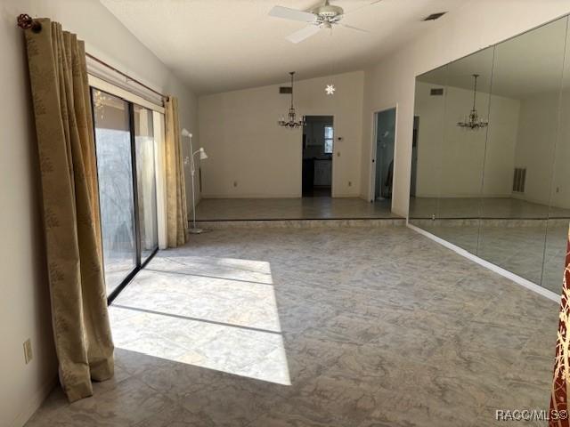 empty room with lofted ceiling and ceiling fan