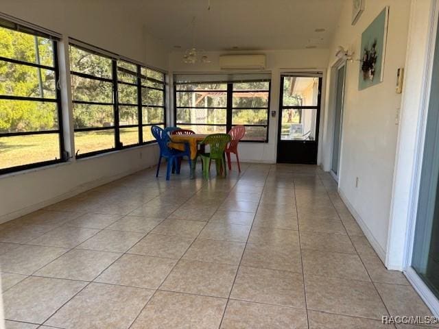 unfurnished sunroom featuring an AC wall unit