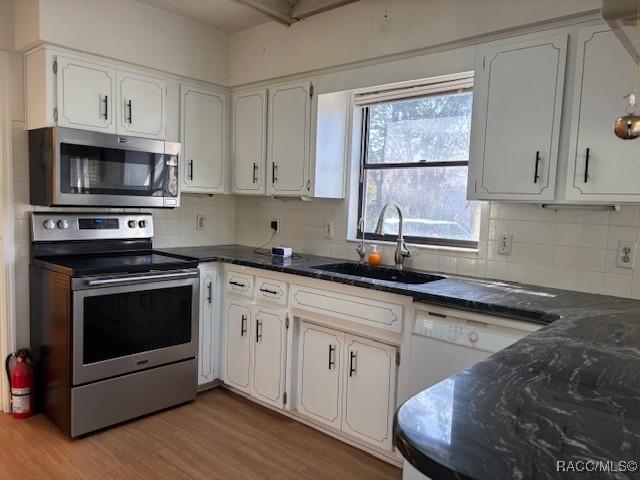 kitchen with white cabinetry, appliances with stainless steel finishes, and sink