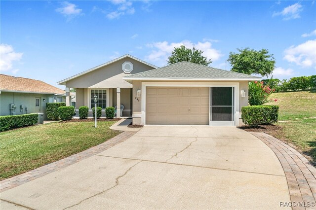 795 W Toucan Loop, Hernando, FL 34442 - ranch-style home featuring stucco siding, concrete driveway, a front yard, an attached garage, and a shingled roof