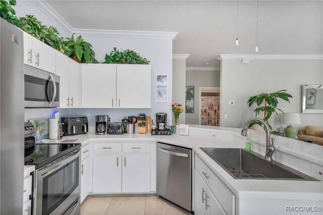 795 W Toucan Loop, Hernando, FL 34442 - kitchen featuring stainless steel appliances, crown molding, a sink, light tile patterned flooring, and light countertops