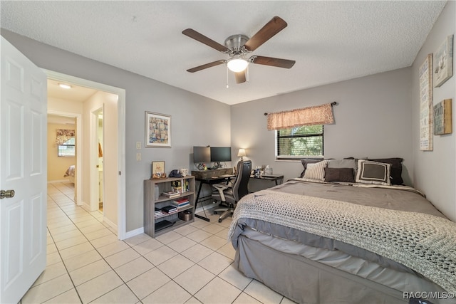 tiled bedroom with a textured ceiling and ceiling fan