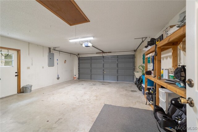 garage featuring electric panel and a garage door opener