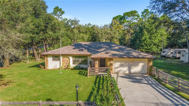 ranch-style house featuring a front yard and a garage