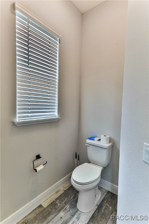 bathroom featuring toilet and hardwood / wood-style flooring