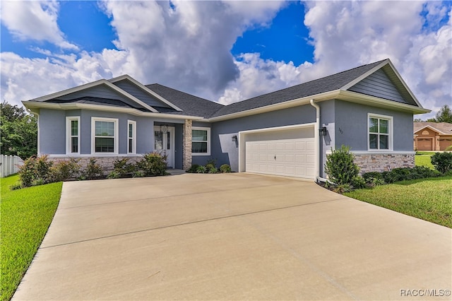 view of front of home featuring a garage and a front yard