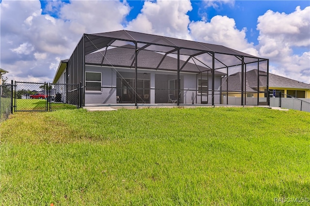 back of house with a lawn and glass enclosure