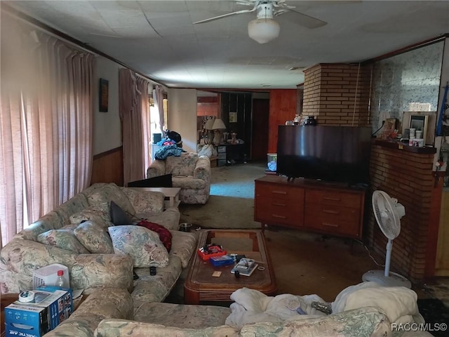 carpeted living room with ceiling fan