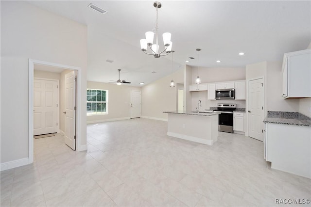 kitchen with an island with sink, white cabinets, stainless steel appliances, and decorative light fixtures