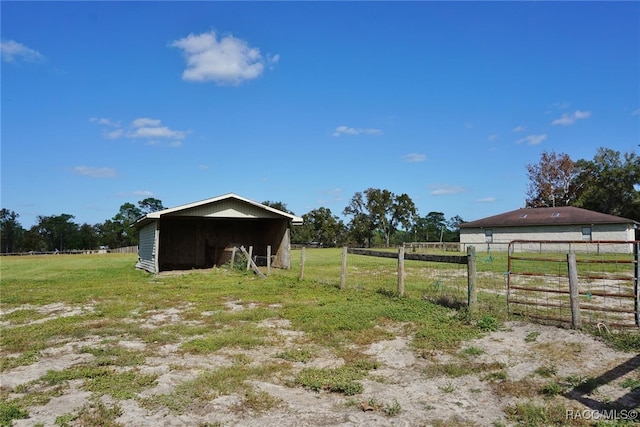 view of yard with a rural view and an outdoor structure