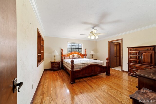 bedroom with light wood-type flooring, ceiling fan, and ornamental molding