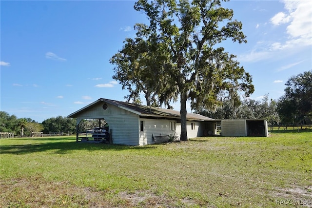 exterior space with an outdoor structure and a lawn