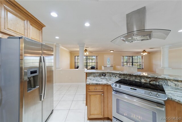 kitchen featuring light stone counters, island range hood, crown molding, and stainless steel appliances